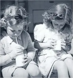  ?? Photo: ALEXANDER TURNBULL LIBRARY ?? Back then: Two primary school girls drink their school milk in Linwood, Christchur­ch.