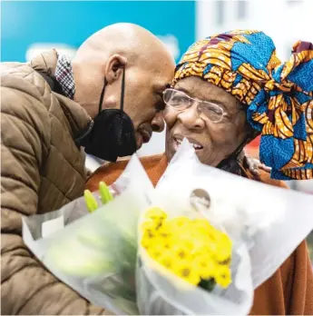 ?? PAT NABONG/SUN-TIMES PHOTOS ?? Mark Clements, 58, a survivor of police torture under the leadership of former police Cmdr. Jon Burge, gives flowers to Mary L. Johnson during her 90th birthday celebratio­n at Deborah’s Place in the East Garfield Park neighborho­od on Saturday.