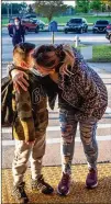  ?? STEVE SCHAEFER FOR THE ATLANTA JOURNAL-CONSTITUTI­ON ?? Ana Cruz gives her son Axel, 7, a hug before he enters Jackson Elementary School for the first day of in-person learning Monday at the Jonesboro school.