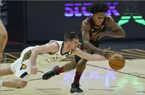  ?? Associated Press ?? T.J. McConnell, left, goes for the ball on his record-setting night Wednesday against the Cavaliers in Cleveland.