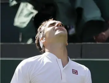  ?? AP ?? Switzerlan­d’s Roger Federer grimaces after losing a point in his Wimbledon quarter- final against Kevin Anderson of South Africa in London on Wednesday. Federer lost 2- 6, 6- 7 ( 5/ 7), 7- 5, 6- 4, 13- 11. —