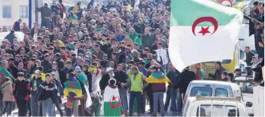  ?? Reuters ?? Algerians carry national flags and rally in Kherrata on Tuesday.