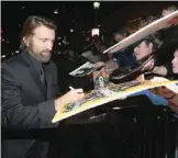  ?? — AFP ?? Actor Sharlto Copley signs autographs during the world premiere of ‘Gringo’ from Amazon Studios and STX Films at Regal LA Live Stadium 14 in Los Angeles, California.