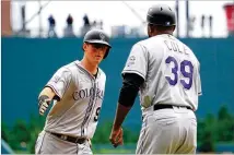  ?? DANIEL SHIREY / GETTY IMAGES ?? DJ LeMahieu hit a solo home run in the third inning as the Rockies beat the Braves 4-2. The Braves’ streak of four consecutiv­e losses ties their longest streak of the season.