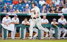  ??  ?? Oregon State designated hitter Kyle Nobach (28) rounds the bases past the Washington dugout after hitting a three-run home run in the seventh inning of the Beavers’ 14-5 win in an eliminatio­n game at the College World Series on Monday.