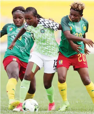  ??  ?? Super Falcons forward, Ngozi Okobi sandwiched by Indomitabl­e Lionesses of Cameroon during their semi-final match on Tuesday at the ongoing 2019 AWCON in Ghana.