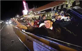  ?? STAFF FILE PHOTO ?? Award-winning photograph­er Richard Wisdom of Discovery Bay, a 2015 Community Service Award winner, rides with his wife, Kay, left, as he waves to the crowd during the 36th annual Holiday Parade in downtown Brentwood in December 2018.