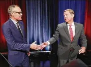  ?? CURTIS COMPTON/CCOMPTON@AJC.COM ?? Lt. Gov. Casey Cagle (left) and Secretary of State Brian Kemp shake hands at the conclusion of their debate Thursday night in Atlanta.