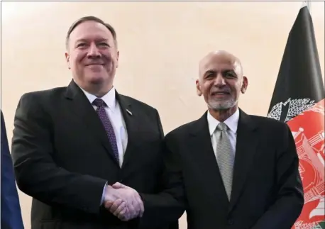  ?? ANDREW CABALLERO-REYNOLDS — POOL PHOTO VIA AP ?? U.S. Secretary of State Mike Pompeo, left, shakes hands with Afghan President Ashraf Ghani,during the 56th Munich Security Conference (MSC) in Munich, southern Germany, on Friday.