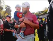  ?? RYAN KANG/AP PHOTO ?? Jon Rahm carries his son Kepa after winning the Genesis Invitation­al on Sunday at Riviera Country Club in the Pacific Palisades area of Los Angeles.
