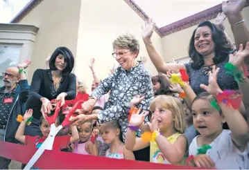  ?? OLIVIA HARLOW/NEW MEXICAN FILE PHOTO ?? Jennifer Salinas, left, director of early learning at the United Way Early Learning Center at Kaune, and United Way of Santa Fe CEO Katherine Freeman, center, cut a ribbon in September 2018 to celebrate the opening of the pre-K program. Under legislatio­n passed earlier this year, pre-K programs will be consolidat­ed under a single state department.