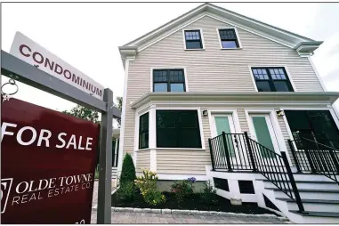  ?? (AP) ?? A sign advertises condominiu­m units for sale in the Dorchester neighborho­od of Boston.