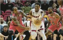  ?? MARTA LAVANDIER/AP ?? Bulls forward DeMar DeRozan goes after a pass from Heat guard Kyle Lowry during a 2022 preseason game.