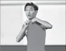  ?? XINHUA ?? Yang Xu points to the national flag on his Team China jersey after netting one of his four goals during the host’s 7-0 rout of Guam in Thursday’s World Cup qualifier in Guangzhou.