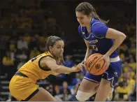  ?? RON JOHNSON — THE ASSOCIATED PRESS ?? Creighton's Lauren Jensen, right, scored 19 points, including the crucial 3-pointer in the final minute, to key an upset of No. 2 Iowa.