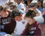  ?? GERALD HERBERT - THE ASSOCIATED PRESS ?? Ryan Schroy, 15, left, Dylan O’Neill, 15, and Kaedree Knox 15, right, embrace each other during a vigil at the Parkland Baptist Church, for the victims of the Wednesday shooting at Marjory Stoneman Douglas High School, in Parkland, Fla., Thursday, Feb....