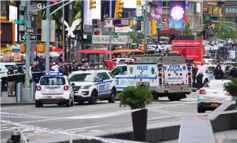  ?? — AFP photo ?? Police officers are seen in Times Square in New York City after the shooting incident.