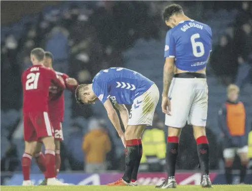  ??  ?? 0 Gareth Mcauley, centre, and defensive colleague Connor Goldson show their frustratio­n at the end of Rangers 1-0 defeat by Aberdeen.
