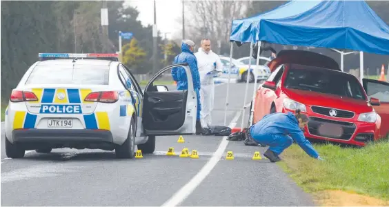  ?? Photo / File ?? Police at the scene of a shooting outside Morrinsvil­le. A gunman armed with a semi-automatic weapon shot at officers and escaped.