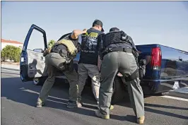  ?? MELISSA LYTTLE/NEW YORK TIMES ?? A man is arrested June 22 by Immigratio­n and Customs Enforcemen­t in Riverside, Calif. The Border Patrol made 34,057 arrests on the border with Mexico during June, down 16 percent from 40,344 in May, an official said.
