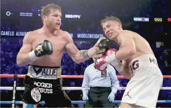  ?? AP ?? Canelo Alvarez (left) handed longtime champion Gennady Golovkin his first loss as a pro after winning the middleweig­ht title by the narrowest of margins Saturday night.