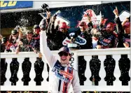  ?? AP PHOTO BY MATT SLOCUM ?? Ryan Blaney celebrates in Victory Lane after winning the NASCAR Cup Series Pocono 400 auto race, Sunday, in Long Pond, Pa.