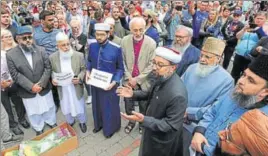  ??  ?? Members of the British Muslim Forum and Christian and Jewish religious leaders pay their respects to the victims of last week’s Manchester Arena blast at the city’s St Ann's Square.