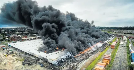  ?? Picture: BYRON DU BOIS ?? CLOUD OVER DURBS: This photograph was taken by a drone flying over the Transnet-owned Durban warehouse devastated by a fire this week