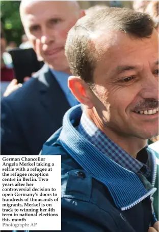  ?? Photograph: AP ?? German Chancellor Angela Merkel taking a selfie with a refugee at the refugee reception centre in Berlin. Two years after her controvers­ial decision to open Germany’s doors to hundreds of thousands of migrants, Merkel is on track to winning her 4th...