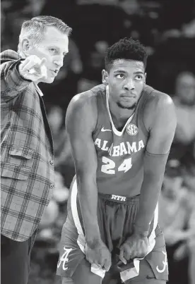  ?? Sean Rayford/associated Press ?? Alabama’s Brandon Miller, right, hit the game-winning shot with 0.9 seconds left in overtime to help the Crimson Tide outlast South Carolina.