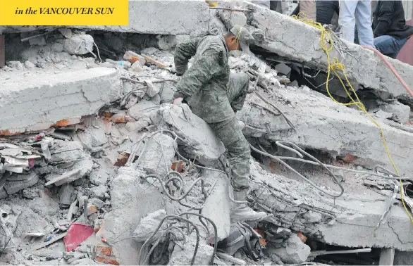  ?? YURI CORTEZ / AFP / GETTY IMAGES ?? Firefighte­rs, policemen, soldiers and volunteers were all part of the search for signs of life in a collapsed building following Tuesday’s earthquake in Mexico City.