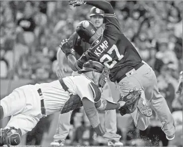  ?? Luis Sinco Los Angeles Times ?? DODGERS CATCHER Yasmani Grandal loses the ball as San Diego Padres outfielder Matt Kemp scores in the fifth inning on a two-run double by Melvin Upton Jr., who then scored on a single by Alexei Ramirez.