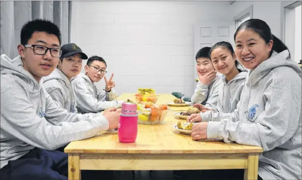  ?? LAWRENCE POWELL ?? Five Grade 7 students and their chaperone arrived at the Trojan Sports Centre in Bridgetown at suppertime on Feb. 8. They were tired after almost 24 hours travelling from China, but after they ate some Canadian food they still had enough energy to tour...