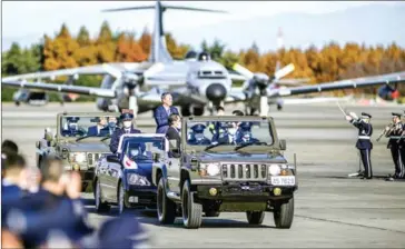  ?? AFP ?? Japanese Prime Minister Yoshihide Suga reviews the Japan Air Self-Defense Force at the Air Self-Defense Force’s Iruma base in Sayama, Saitama Prefecture on November 28.