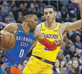  ?? Sue Ogrocki Associated Press ?? LONZO BALL, chasing Russell Westbrook last month, didn’t enter the NBA with a reputation for defense, but he’s made strides and has been missed by the Lakers.