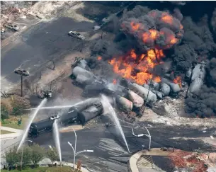  ?? PAUL CHIASSON/THE CANADIAN PRESS FILE PHOTO ?? After the deadly July 2013 rail disaster in Lac-Mégantic, Que., new tracks will be routed around the town instead of through it. Many other Canadian municipali­ties are pushing to reroute tracks.