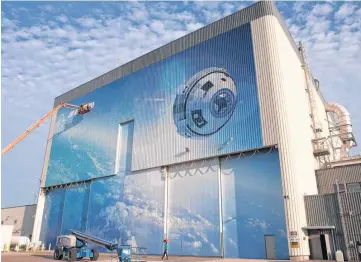  ??  ?? A mural depicts Boeing’s newly named CST-100 Starliner commercial crew transporta­tion spacecraft on the company’s Commercial Crew and Cargo Processing Facility at NASA’s Kennedy Space Center in Florida. The building was formerly a processing site for...