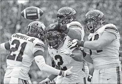  ?? [KYLE ROBERTSON/DISPATCH] ?? Ohio State running back J.K. Dobbins (2) celebrates his 1-yard touchdown run in the third quarter with receiver Parris Campbell, left, right tackle Isaiah Prince, middle, and center Billy Price.