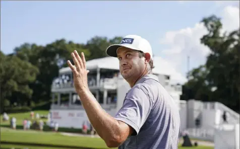  ?? Associated Press ?? Harris English waves to the crowd after hitting a hole in one on No. 15 in the first round of the Tour Championsh­ip.