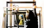  ??  ?? In this file photo shows Johannes Vermeer’s “Girl with a Pearl Earring” painting inside a XRF macro-scanner during a research at The Mauritshui­s in The Hague. –AFP