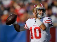  ??  ?? San Francisco 49ers quarterbac­k Jimmy Garoppolo passes against the Los Angeles Rams during the first half of an NFL football game Sunday in Los Angeles. AP PHOTO