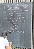  ?? —AFP ?? ‘VICTIM OF INCEST’, ‘HIV+’ A volunteer writes the day’s list of titles of ‘human books.’