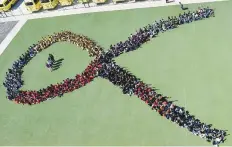  ?? Ahmed Ramzan/Gulf News ?? Students of Springdale­s School in Al Quoz form a human ribbon in support of breast cancer awareness yesterday.