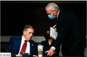  ?? ANDREW HARNIK/AP ?? Sen. Ron Johnson (right), R-wis., leaves a card Tuesday with ex-u.s. Capitol Police Chief Steven Sund as he exits a Senate hearing in Washington about the Jan. 6 riot.