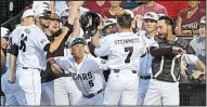  ?? NWA Democrat-Gazette/ANDY SHUPE ?? Missouri State’s Hunter Steinmetz (7) is congratula­ted by teammates after hitting a home run in the first inning against Arkansas on Saturday night in the NCAA Fayettevil­le Regional. Missouri State won 5-4, sending the Hogs to an eliminatio­n game today.