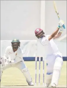  ??  ?? Wicketkeep­er Shane Dowrich hits down the ground during his 103 against Zimbabwe on yesterday’s fourth day of the second Test. (Photo courtesy CWI Media)