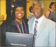  ??  ?? Johnson poses for a photo with her grandfathe­r, Lindsey Johnson Sr., during celebratio­ns for her graduation from Valdosta State University.