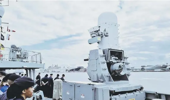  ?? ?? Some of HMS Dauntless's ship's company pictured on the destroyer's deck as she heads to sea.