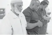  ??  ?? Haywood Shakir Talib prays before breaking fast during Ramadan at Masjid Warithud-deen Mohammed last week.