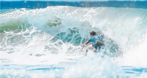  ?? Picture: WSL ?? Stephanie Gilmore pulls out of a barrel during her tight loss to Carissa Moore in the non-eliminatio­n third round at the Roxy Pro yesterday.